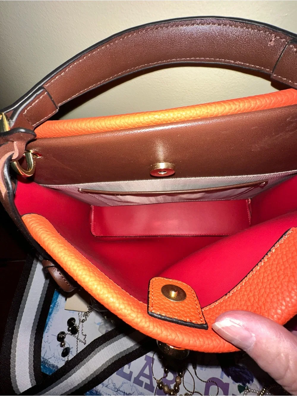 Orange hand Bag with Dark Brown Trim two crossbody straps..filled